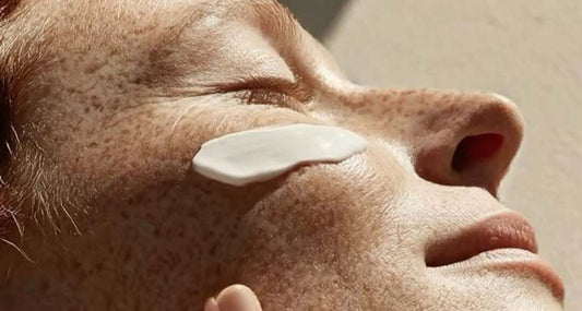 Woman applying a charcoal face mask for deep pore cleansing and oil control