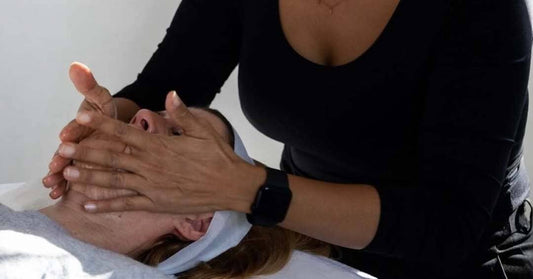 Woman examining blackheads on her nose before using a face mask
